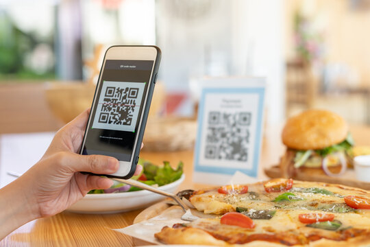 Woman use smartphone to scan QR code to pay in cafe restaurant with a digital payment without cash. Choose menu and order accumulate discount. E wallet, technology, pay online, credit card, bank app. - Powered by Adobe