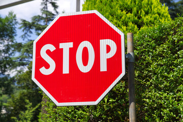 Close-up of red and white stop sign with octagon shape at Italian city of Meran on a sunny summer day. Photo taken July 15th, 2024, Meran Merano, Italy.