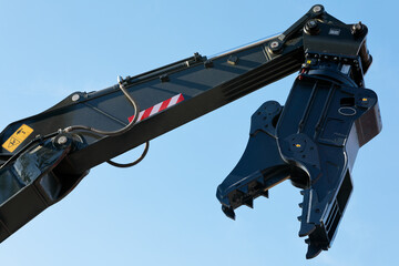 excavator arm with rotating crusher attachment