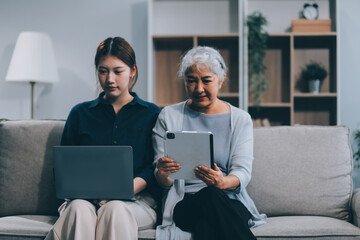 Asian elderly women and friend using social media and living room. Video streaming, happiness and conversation at a house with old people together