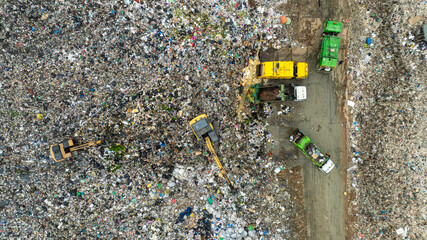 truck waste dump and backho work, Waste from household in waste landfill disposal pile plastic garbage and various trash, Environmental pollution warning.