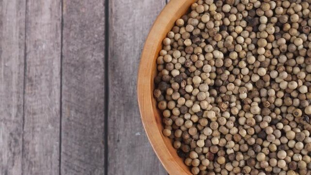 overhead shot of a spinning wooden plate of coriander seeds