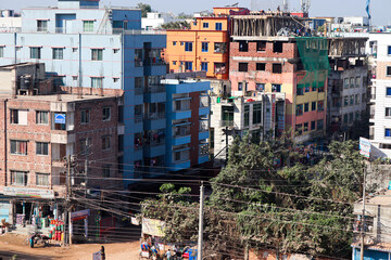 Fototapeta premium Colorful Urban Residential Area with People Engaged in Daily Activities and Construction Work under Clear Blue Sky
