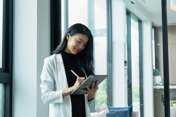 Businesswoman working using tablet.