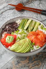 Sushi rice bowl recipe consists of sushi-grade seafood, the freshest toppings, and fluffy sushi rice to keep things healthy and satisfying closeup on the table. Vertical