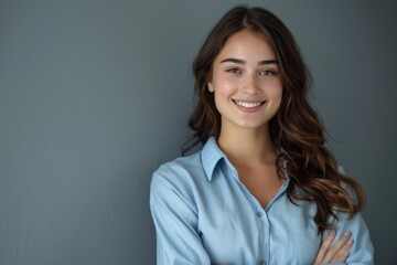 Fototapeta premium The young woman crossed her hands and looked at the camera with a smile