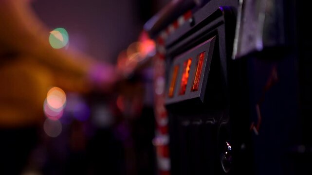 Pinball machine coin door at arcade with person in background 4k
