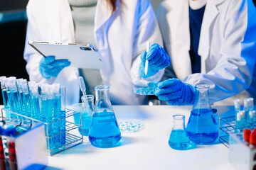 Fototapeta premium Scientist team meeting and writing analysis results in the laboratory study and analyze scientific