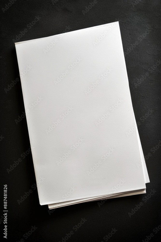 Poster a simple scene with a piece of white paper sitting on a table, possibly for writing or note-taking