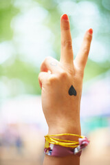 Making a fashion statement. A young woman with a heart tattoo on her hand.