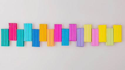 Vibrant pieces of children's playdough plastic clay in a variety of colors, showcasing soft texture and rich