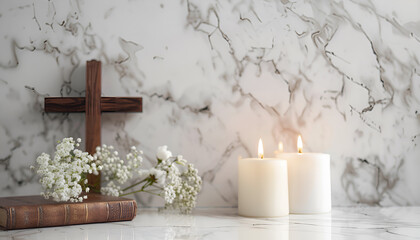 Burning church candles, wooden cross, Bible and flowers on white marble table. Space for text