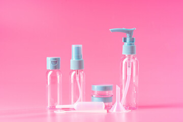 Empty Travel Bottles and Accessories on a Pink Background