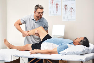 Leg pain, physiotherapy and man with mature patient for wellness, medical service and consulting....