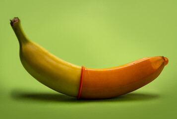 Banana in condom. LGBT. LGBTQ. Safe sex concept. Condom contraception. Sex protection. Birth...