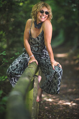 Youthful mature woman on fence