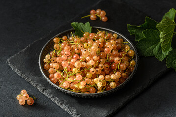 white currant on a black plate