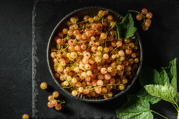 white currant on a black plate