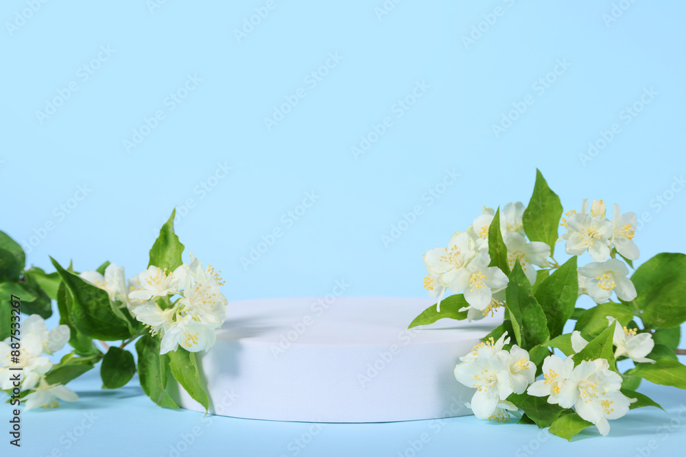 Wall mural Presentation of product. White podium and beautiful jasmine flowers on light blue background, space for text