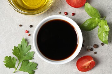 Balsamic vinegar, oil and other products on light grey table, flat lay
