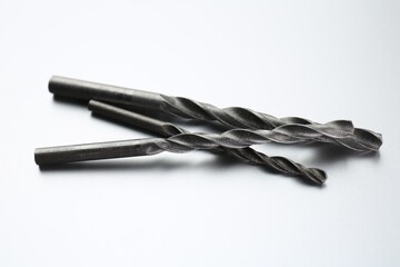 Different drill bits on light grey background