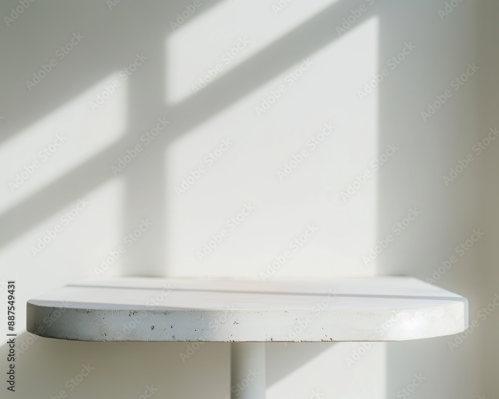 Poster Soft White Display Table with Blurred Celebration Background and Natural Sunlight Creating a Joyful Bokeh Effect