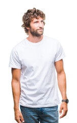 Obraz premium Handsome hispanic model man over isolated background looking away to side with smile on face, natural expression. Laughing confident.