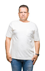 Fototapeta premium Middle age arab man wearig white t-shirt over isolated background Relaxed with serious expression on face. Simple and natural looking at the camera.