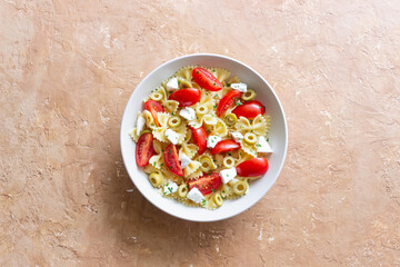 Farfalle pasta with white cheese, tomatoes and olives. Healthy eating. Vegetarian food.
