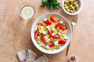 Farfalle pasta with white cheese, tomatoes and olives. Healthy eating. Vegetarian food.