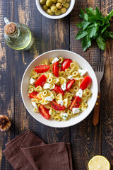 Farfalle pasta with white cheese, tomatoes and olives. Healthy eating. Vegetarian food.