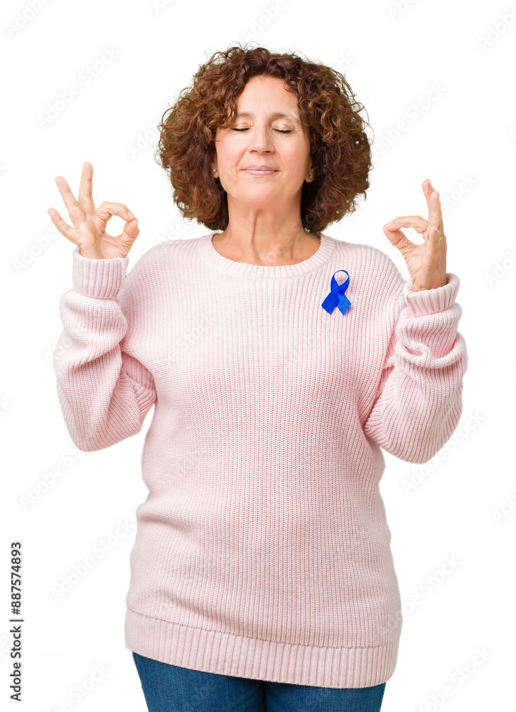 Wall mural Middle ager senior woman wearing changeable blue color ribbon awareness over isolated background relax and smiling with eyes closed doing meditation gesture with fingers. Yoga concept.