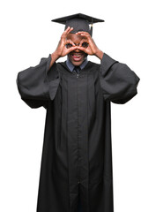 Young graduated african american man over isolated background doing ok gesture like binoculars sticking tongue out, eyes looking through fingers. Crazy expression.