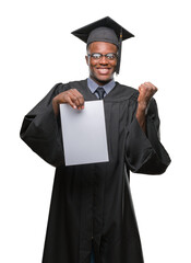 Young graduated african american man holding blank paper degree over isolated background screaming proud and celebrating victory and success very excited, cheering emotion