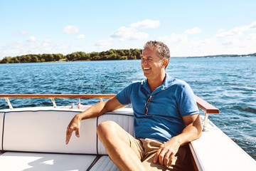 Thinking, mature man and boat on vacation for travel, sailing and ideas of adventure journey on...