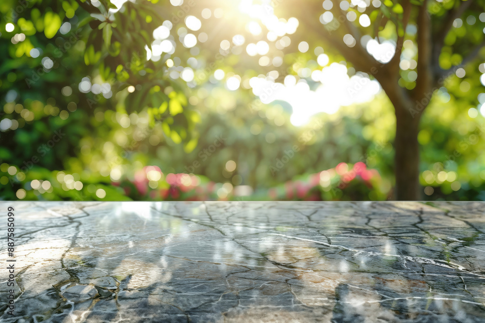 Poster empty marble table reflecting sunlight in a garden with blurred green trees and flowers for a natura