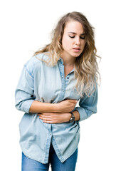 Beautiful young blonde woman over isolated background with hand on stomach because nausea, painful disease feeling unwell. Ache concept.