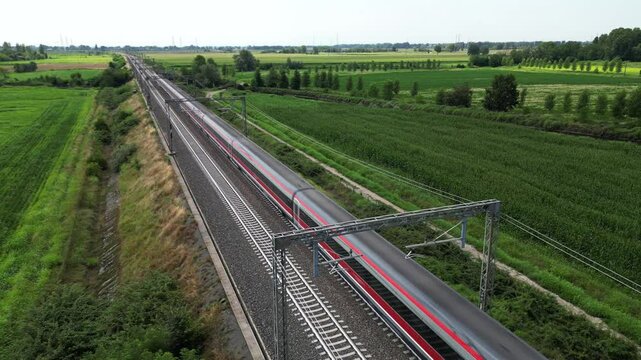 Europe, Italy , Milan - Frecciarossa Hight speed 300km h train raylway from Milano  to Rome view from the drone - the faster way to travel in Italy for tourist and passengers - tourist destination 