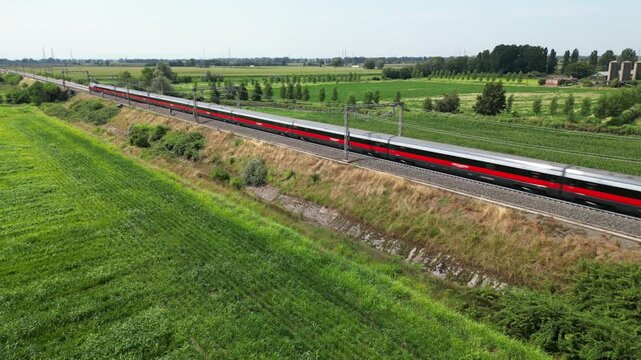 Europe, Italy , Milan - Frecciarossa Hight speed 300km h train raylway from Milano  to Rome view from the drone - the faster way to travel in Italy for tourist and passengers - tourist destination 