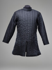 Historical fashion. Medieval knight cloth. Padded jacket gambeson.