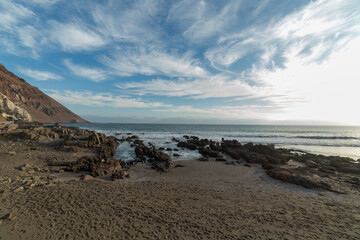 wide-angle view of the beaches south of Arica, on the Pacific Ocean, with a clear sky, rough seas and no people around