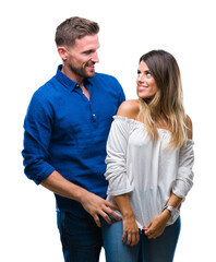 Young couple in love over isolated background looking away to side with smile on face, natural expression. Laughing confident.