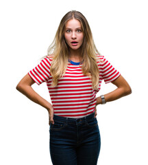 Fototapeta premium Young beautiful blonde woman over isolated background afraid and shocked with surprise expression, fear and excited face.