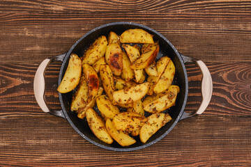 Potato wedges roasted in oven with thyme and salt