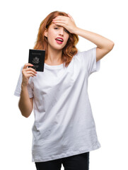 Fototapeta premium Young beautiful woman holding passport of united states of america over isolated background stressed with hand on head, shocked with shame and surprise face, angry and frustrated. Fear and upset
