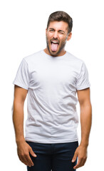Fototapeta premium Young handsome man over isolated background sticking tongue out happy with funny expression. Emotion concept.