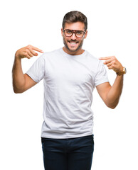 Young handsome man wearing glasses over isolated background looking confident with smile on face, pointing oneself with fingers proud and happy.