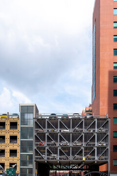 This image showcases a multi-level parking garage with various cars parked on different levels, capturing the essence of urban architecture and transportation infrastructure  in Rotterdam