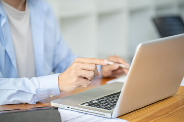 Business man working by using laptop computer Hands typing on a keyboard. Professional investor working new start up project. business planning in office. Technology business Concept.