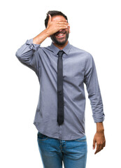 Adult hispanic business man over isolated background smiling and laughing with hand on face covering eyes for surprise. Blind concept.